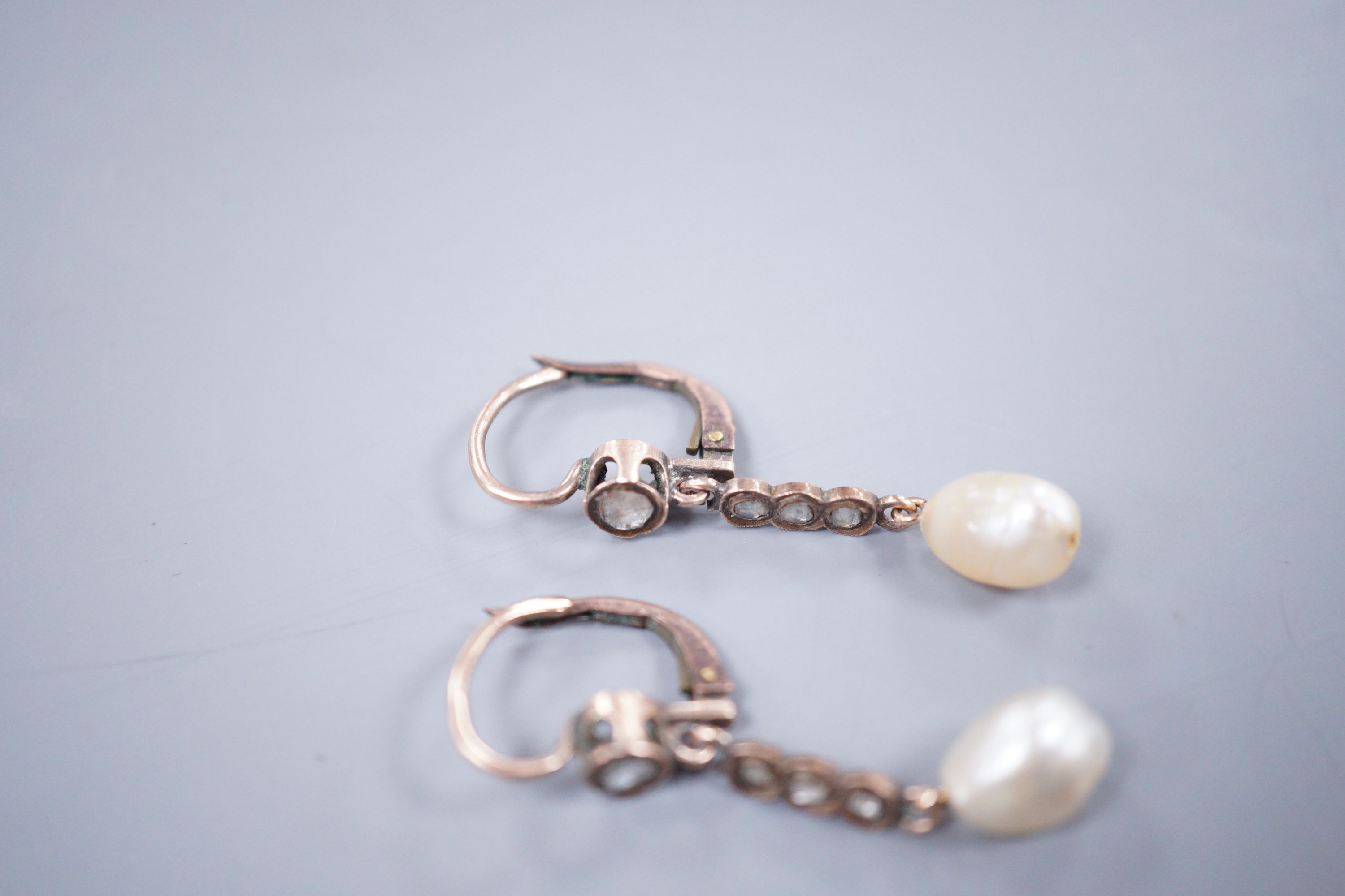 A pair of yellow metal, baroque pearl and rose cut diamond set drop earrings, 38mm and a similar pendant, gross weight 5.9 grams.